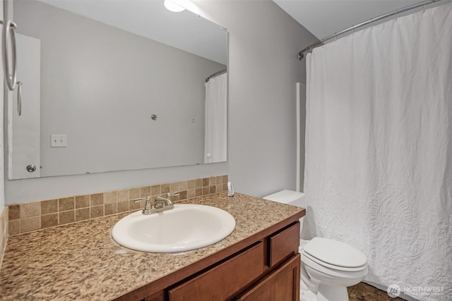 bathroom with vanity, toilet, and curtained shower