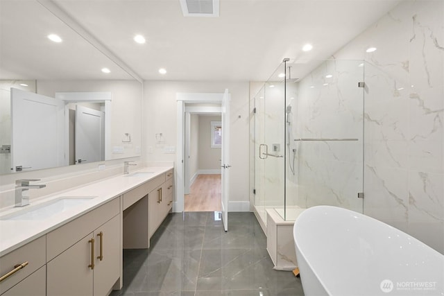 bathroom with a sink, a marble finish shower, marble finish floor, visible vents, and recessed lighting