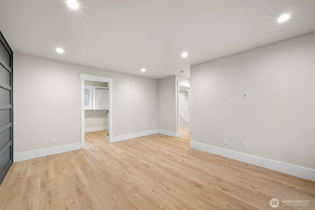 unfurnished living room featuring recessed lighting, light wood-style flooring, and baseboards
