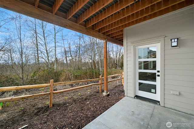 doorway to property featuring fence