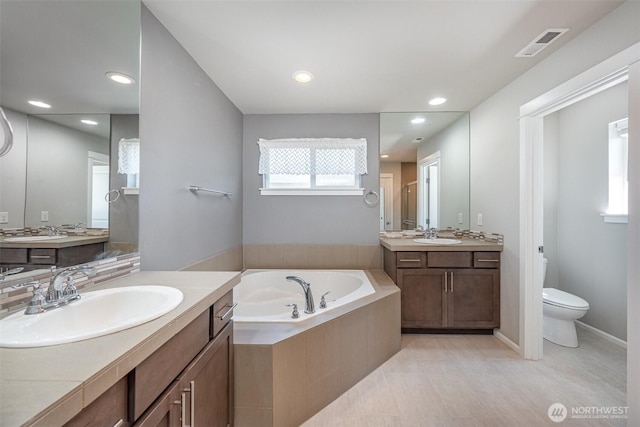 24524 96th Ave S, Kent, WA 98030 - full bath featuring a garden tub, a shower stall, toilet, two vanities, and recessed lighting