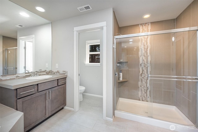 24524 96th Ave S, Kent, WA 98030 - bathroom featuring a shower stall, toilet, vanity, baseboards, and tile patterned floors