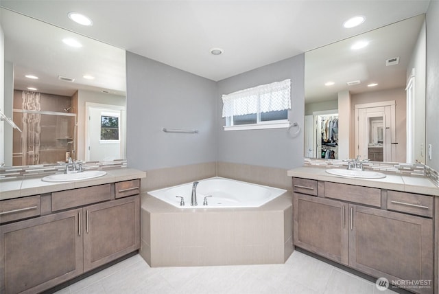 24524 96th Ave S, Kent, WA 98030 - bathroom featuring a stall shower, a garden tub, two vanities, tile patterned floors, and recessed lighting