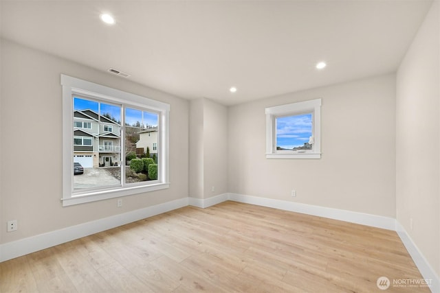 spare room with baseboards, visible vents, recessed lighting, and light wood-style floors