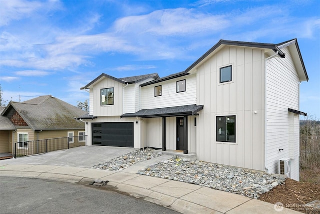 modern inspired farmhouse with board and batten siding, an attached garage, concrete driveway, and fence