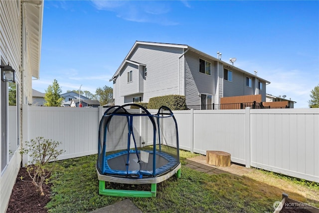 view of yard featuring a fenced backyard and a trampoline