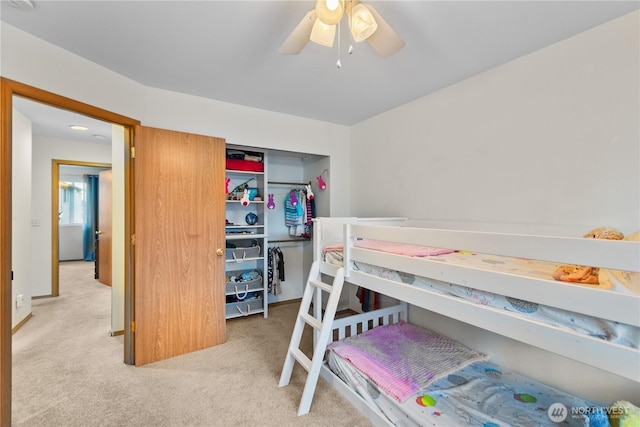 bedroom with a closet, carpet flooring, and a ceiling fan