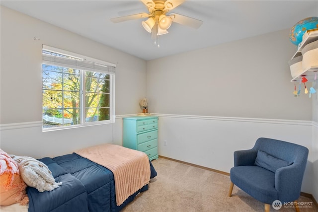 bedroom with baseboards, ceiling fan, and light carpet