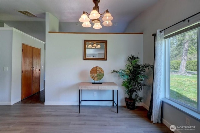 19802 118th Avenue Ct E, Graham, WA 98338 - hallway featuring a chandelier, wood finished floors, and lofted ceiling