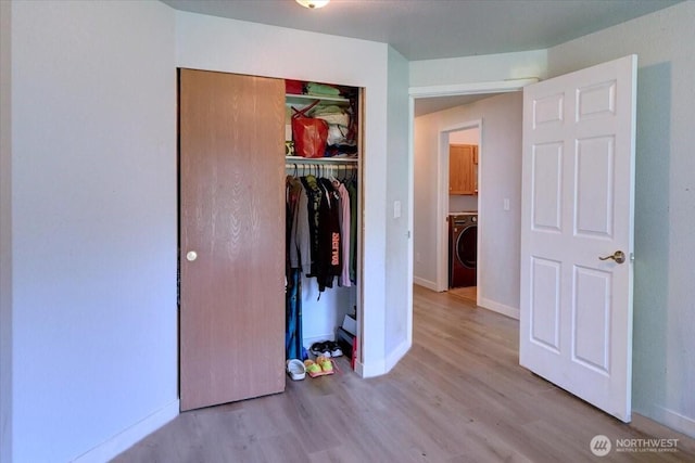 19802 118th Avenue Ct E, Graham, WA 98338 - unfurnished bedroom with washer / clothes dryer, wood finished floors, and a closet