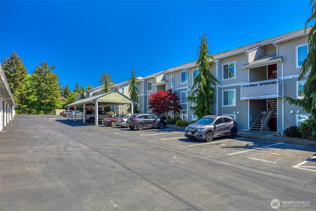 partially covered parking lot featuring stairway