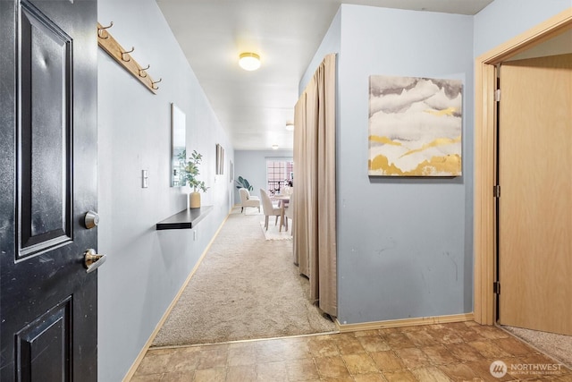 corridor featuring carpet floors and baseboards