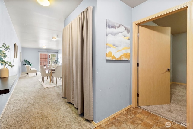 corridor with carpet floors and baseboards