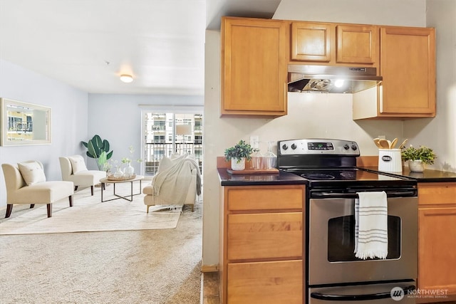 kitchen with stainless steel electric range oven, carpet flooring, dark countertops, open floor plan, and under cabinet range hood