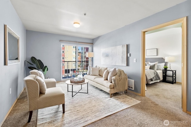 living area featuring baseboards, carpet flooring, and visible vents