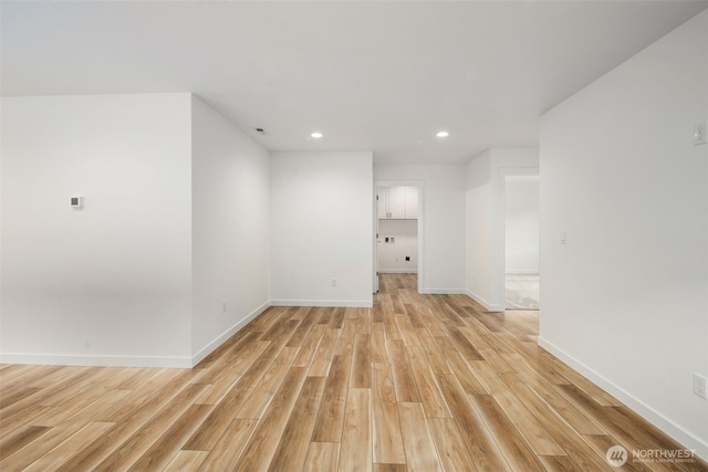unfurnished room featuring baseboards, recessed lighting, and light wood finished floors