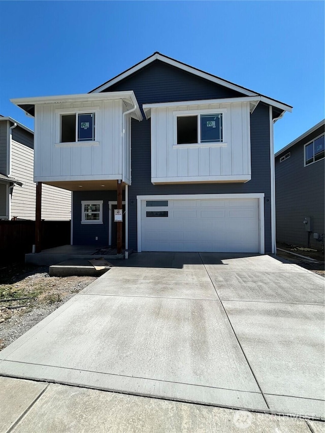 17859 26th Dr NE, Marysville, WA 98271 - view of front of home featuring an attached garage, driveway, and board and batten siding