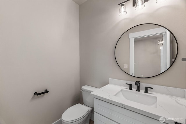 half bath featuring toilet and vanity