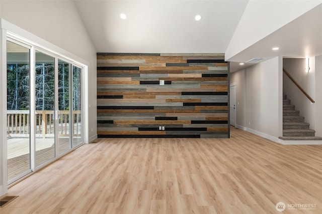 spare room with recessed lighting, wood finished floors, visible vents, baseboards, and stairs