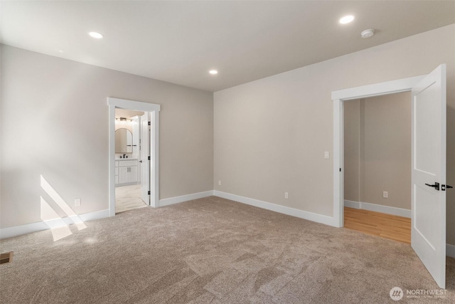 unfurnished bedroom with carpet floors, visible vents, and recessed lighting