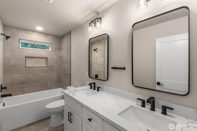 full bathroom featuring double vanity, shower / bathtub combination, toilet, and a sink