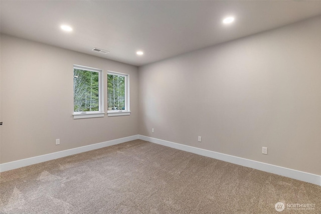 carpeted empty room featuring recessed lighting, visible vents, and baseboards