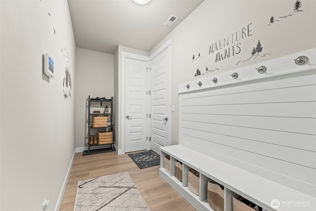 mudroom featuring light wood-style floors, baseboards, and visible vents