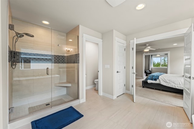 ensuite bathroom with toilet, recessed lighting, connected bathroom, a ceiling fan, and a stall shower