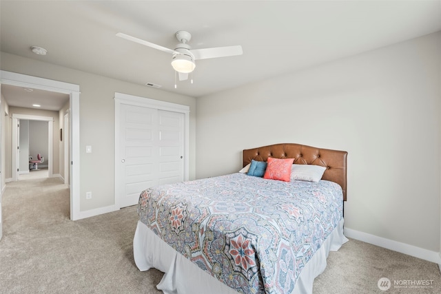 bedroom with a closet, baseboards, a ceiling fan, and carpet flooring