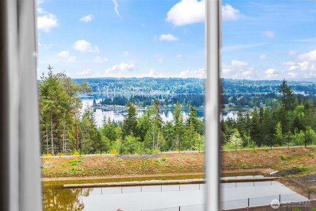 view of mountain feature featuring a view of trees and a water view