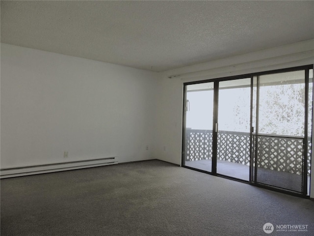 empty room featuring carpet flooring, a textured ceiling, and a baseboard heating unit