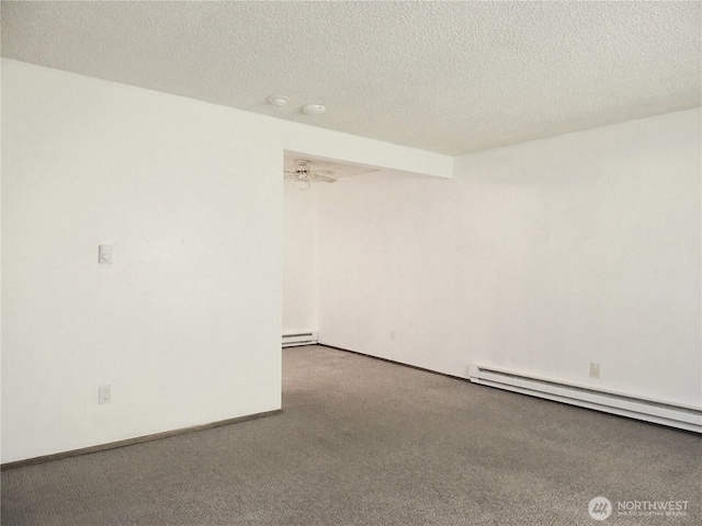 carpeted empty room with a textured ceiling, a baseboard heating unit, and baseboards