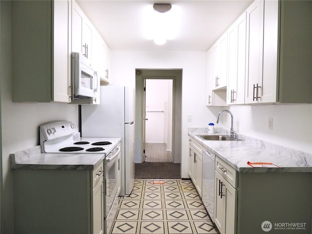 kitchen featuring a sink, white cabinets, white appliances, and light countertops