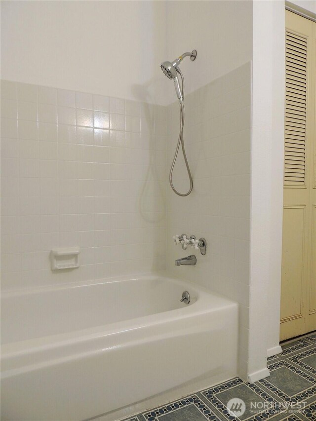 bathroom with tile patterned flooring and tub / shower combination