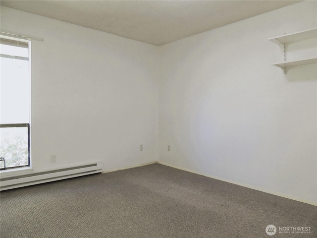 empty room with carpet floors, a baseboard heating unit, and a wealth of natural light