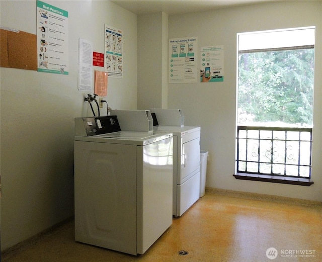 common laundry area with separate washer and dryer, baseboards, and plenty of natural light