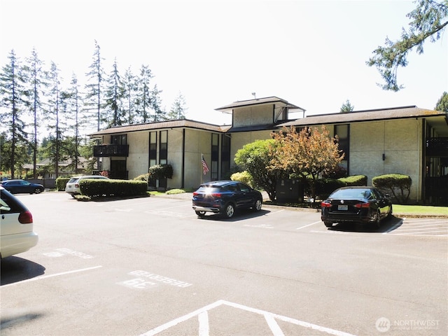 view of front of home featuring uncovered parking and stucco siding