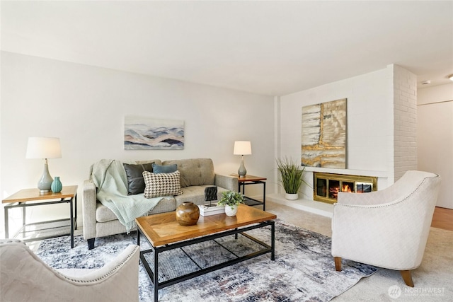living room with a glass covered fireplace and carpet floors