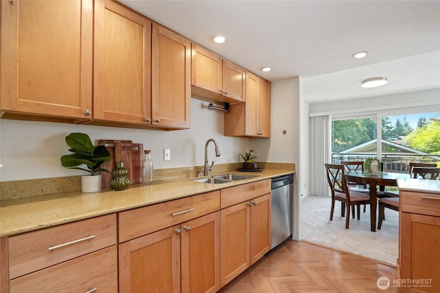 kitchen featuring stainless steel dishwasher, light stone countertops, recessed lighting, and a sink