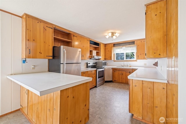 kitchen featuring stainless steel appliances, open shelves, light countertops, a sink, and a peninsula