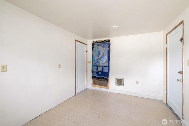 unfurnished room with tile patterned floors