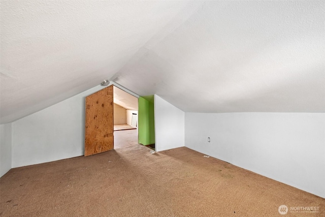 additional living space with lofted ceiling and carpet floors