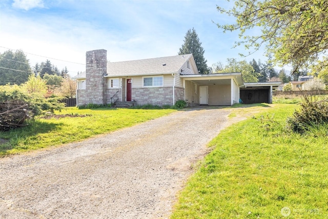 view of front facade with driveway, cooling unit, an attached carport, a chimney, and a front lawn