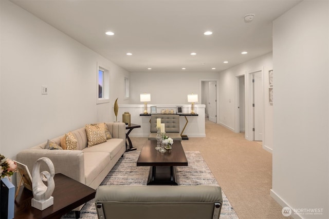 living area with recessed lighting, baseboards, and light carpet