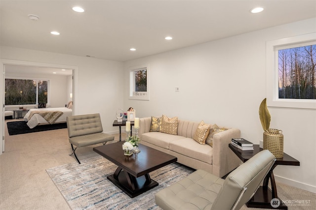 living room with recessed lighting, baseboards, and light carpet
