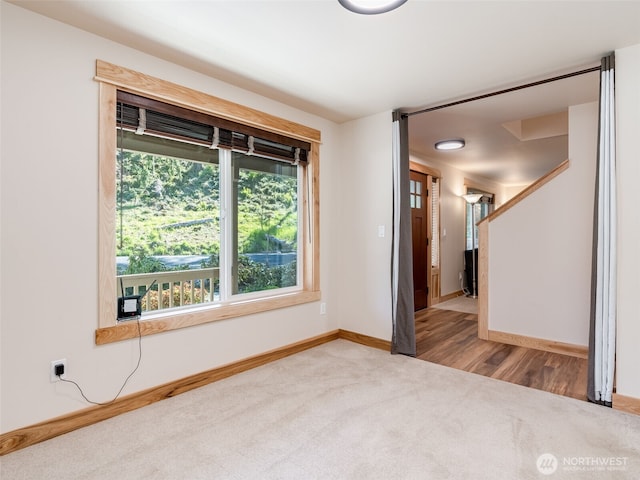 unfurnished room featuring baseboards and carpet flooring