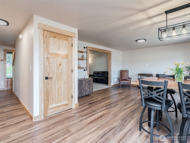 dining room with wood finished floors and baseboards