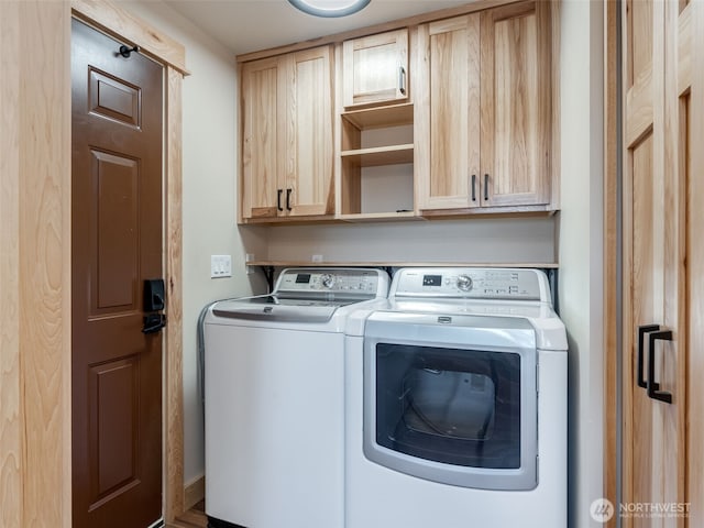 laundry room featuring cabinet space and washing machine and dryer