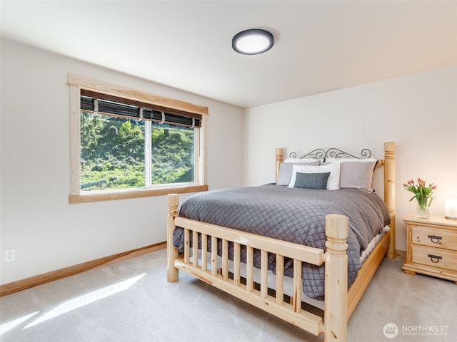 bedroom with baseboards and carpet