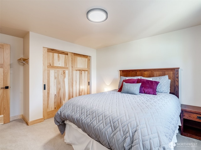 carpeted bedroom featuring baseboards